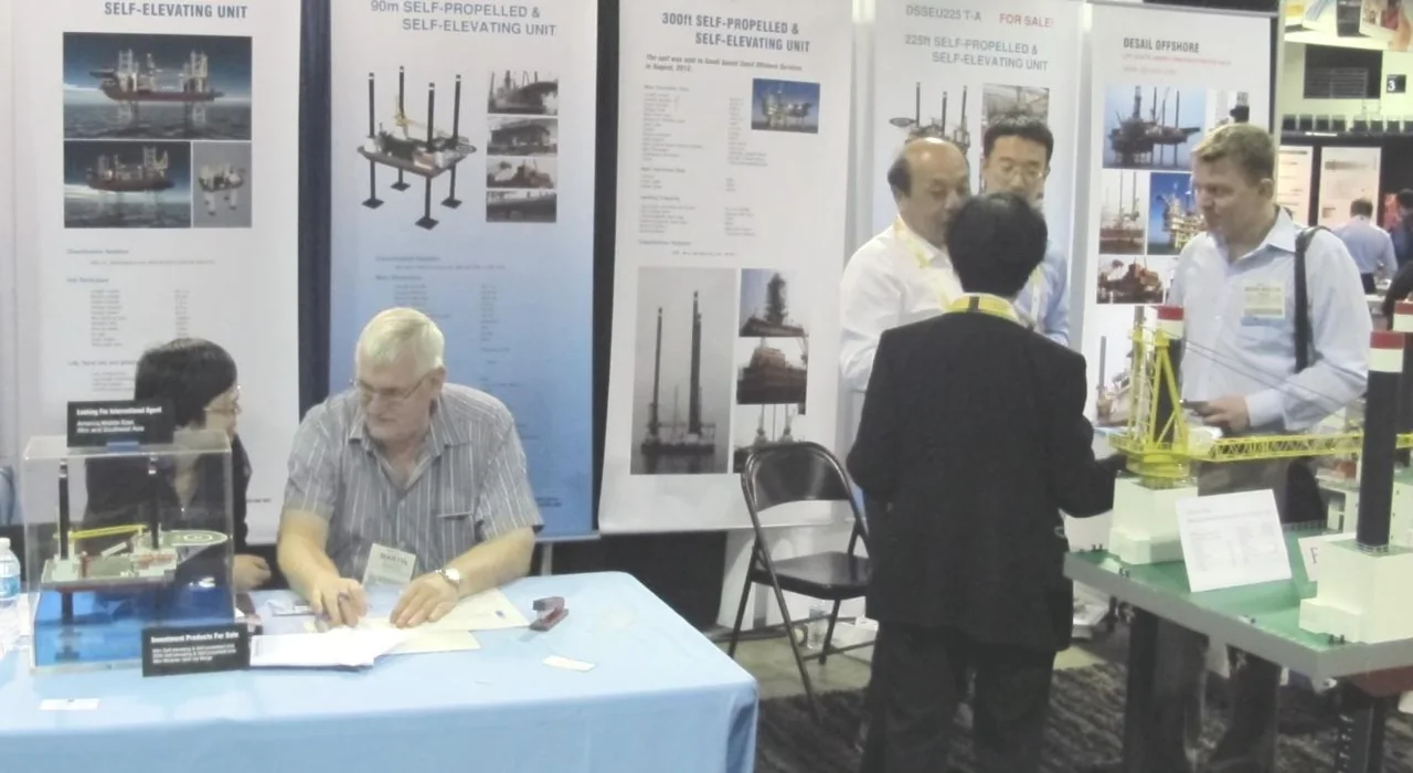 DESAIL representatives in discussion with visitors at a marine industry exhibition