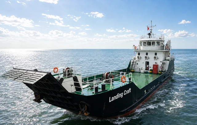 Black and green 45 metre Desail landing craft underway with bow ramp raised